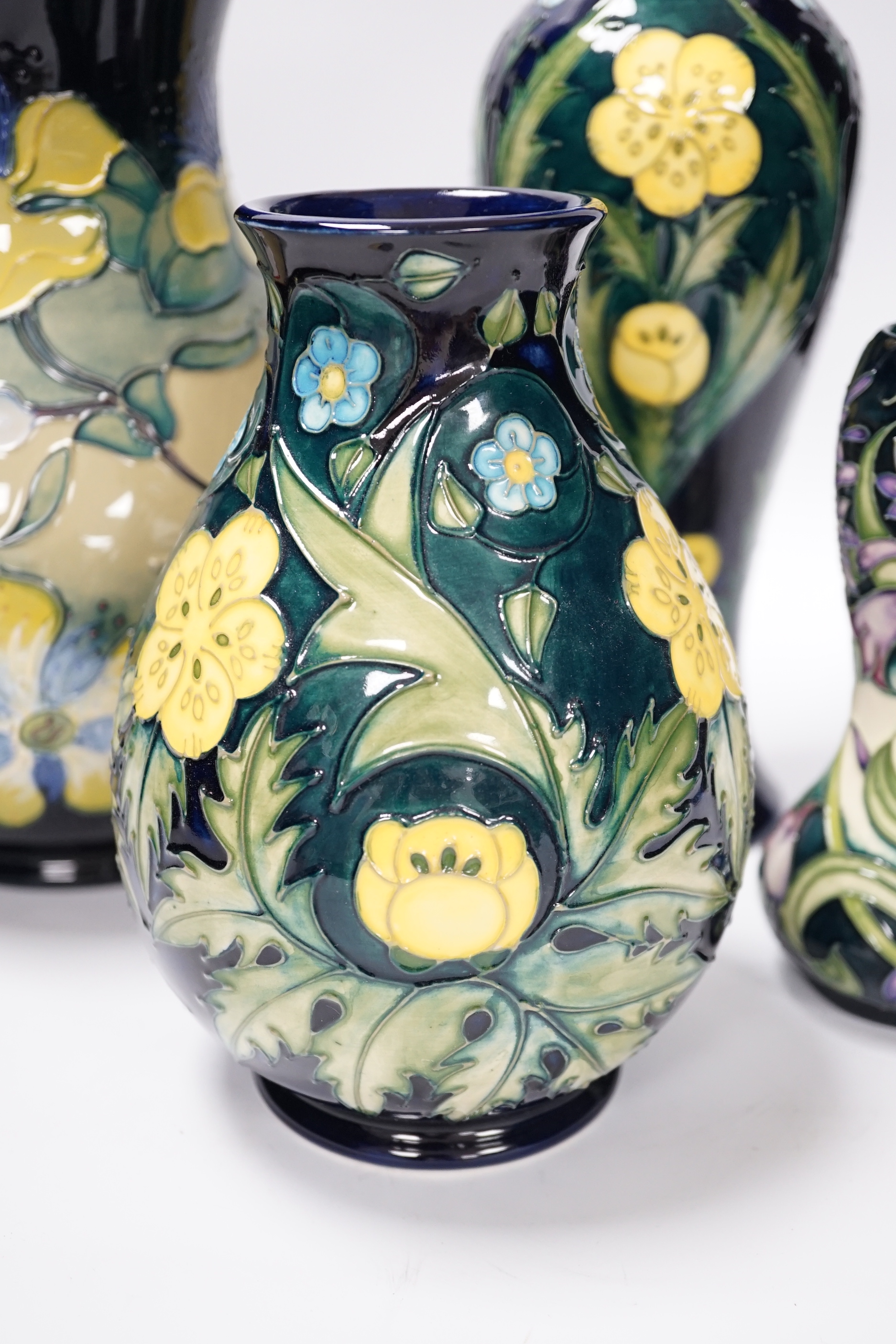 Two Moorcroft 'buttercup' vases and two other Moorcroft vases, tallest 31cm (4)